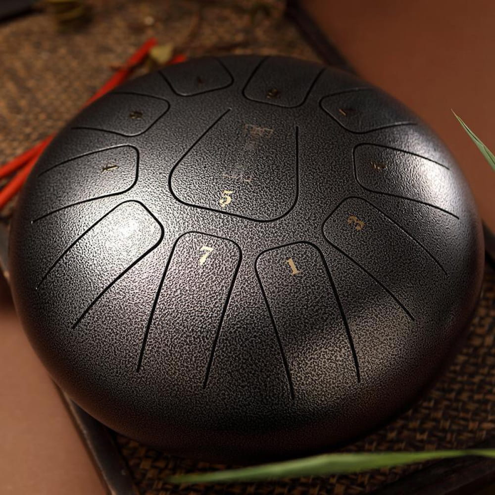 Steel tongue drum with segmented panels in a circular pattern for musical enjoyment