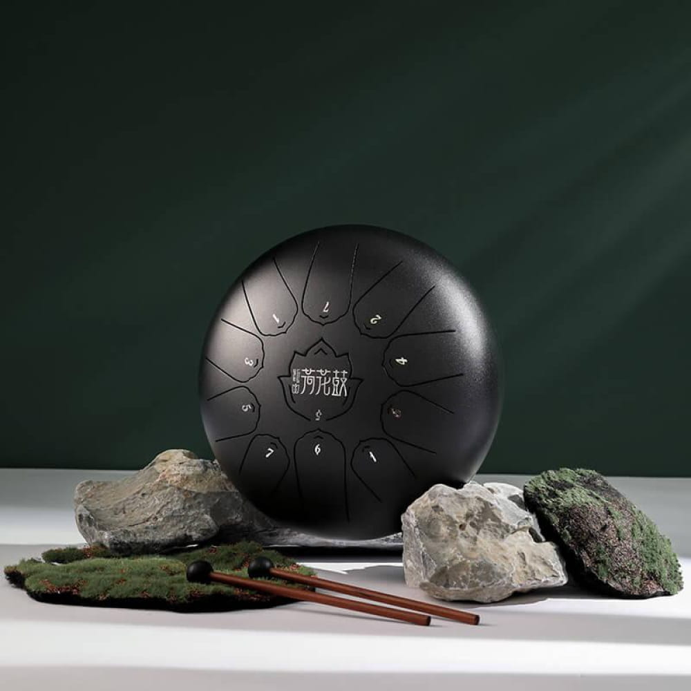 Black steel tongue drum with 11 notes in C Major, featuring circular tone zones