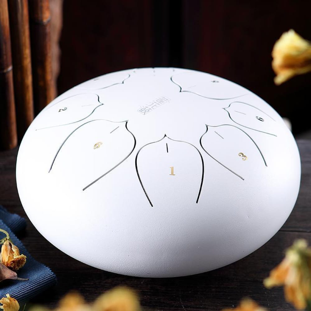 White oval-shaped drum with curved patterns, part of 12 Inch Carbon Steel Tongue Drum