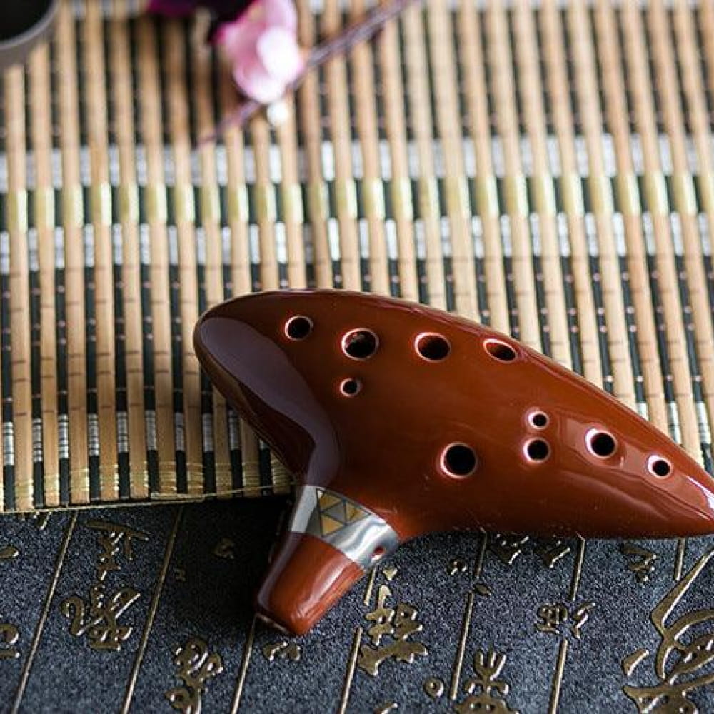 Brown ceramic 12-hole Alto C Ocarina flute with multiple finger holes and unique colors