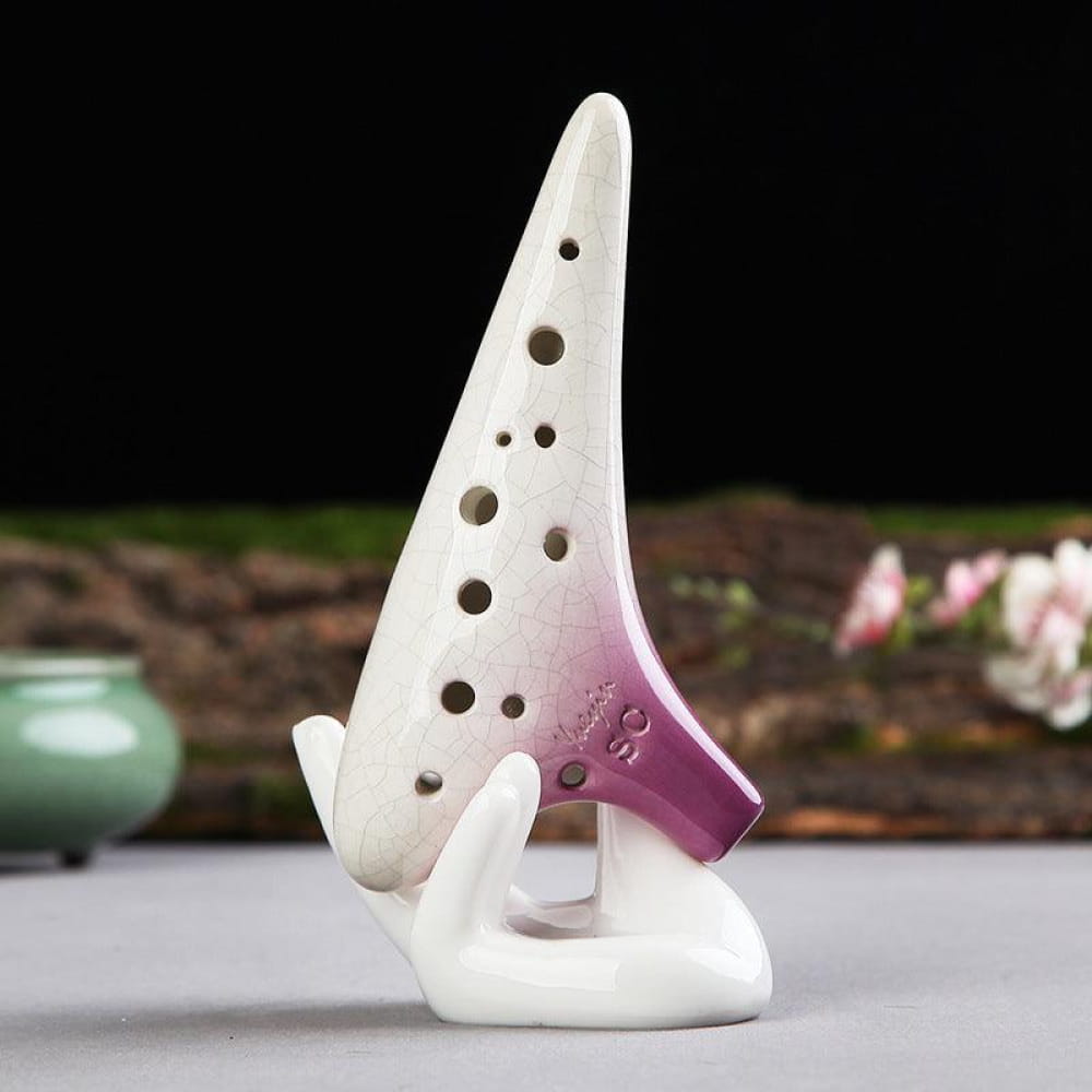White ceramic Ocarina with purple base on curved stand for Treble Wind Instrument