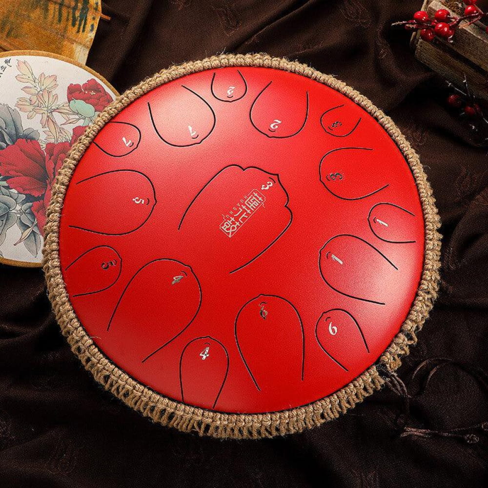 Red steel tongue drum with numbered tone zones and decorative edge trim, 13-Inch D Key