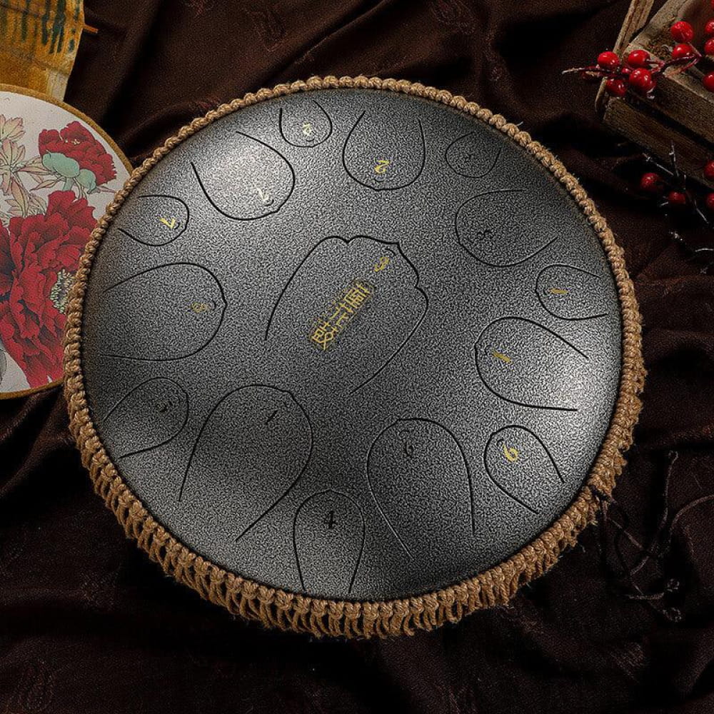 14-Inch Carbon Steel Tongue Drum with circular tone pads and woven rope border