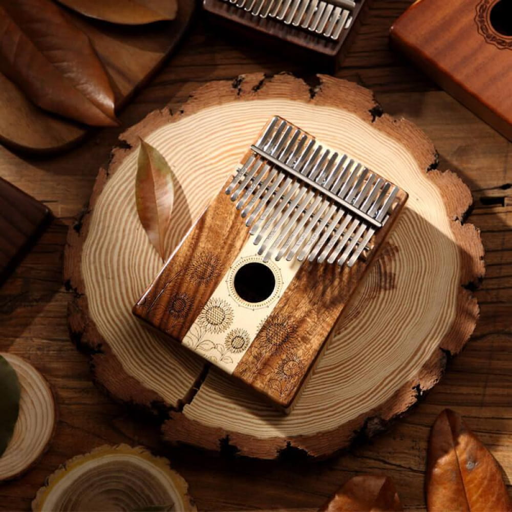 Wooden Kalimba thumb piano with metal tines on a tree ring slice, 17 Key Acacia & Maple