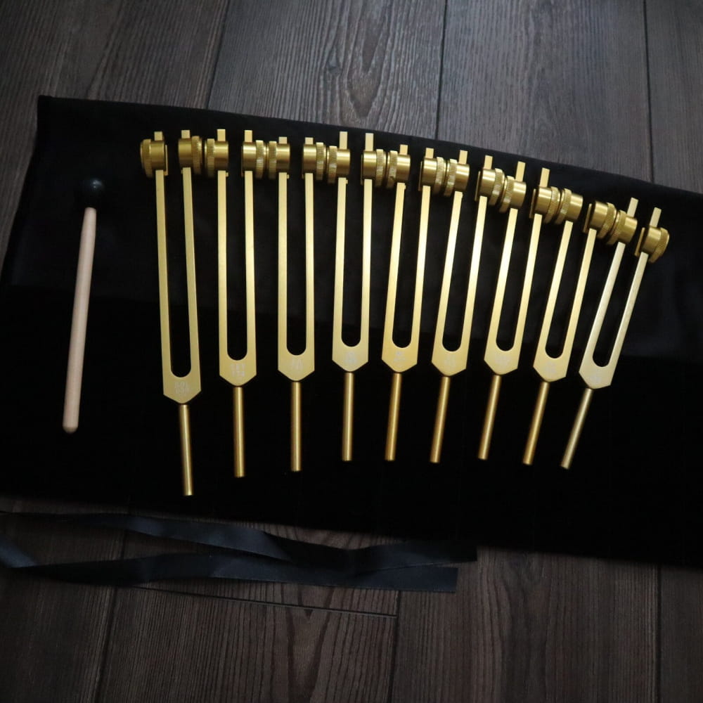 Set of golden tuning forks in ascending size for Solfeggio and Chakra healing