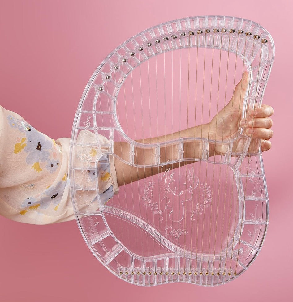Clear acrylic heart-shaped harp in the 21-String Crystal Lyre Harp Instrument