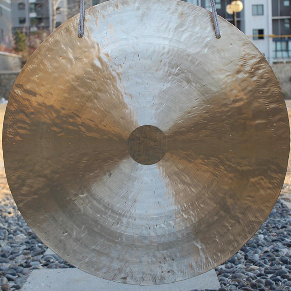 Circular metallic gong with textured surface for sound healing, 26 inch, includes stand