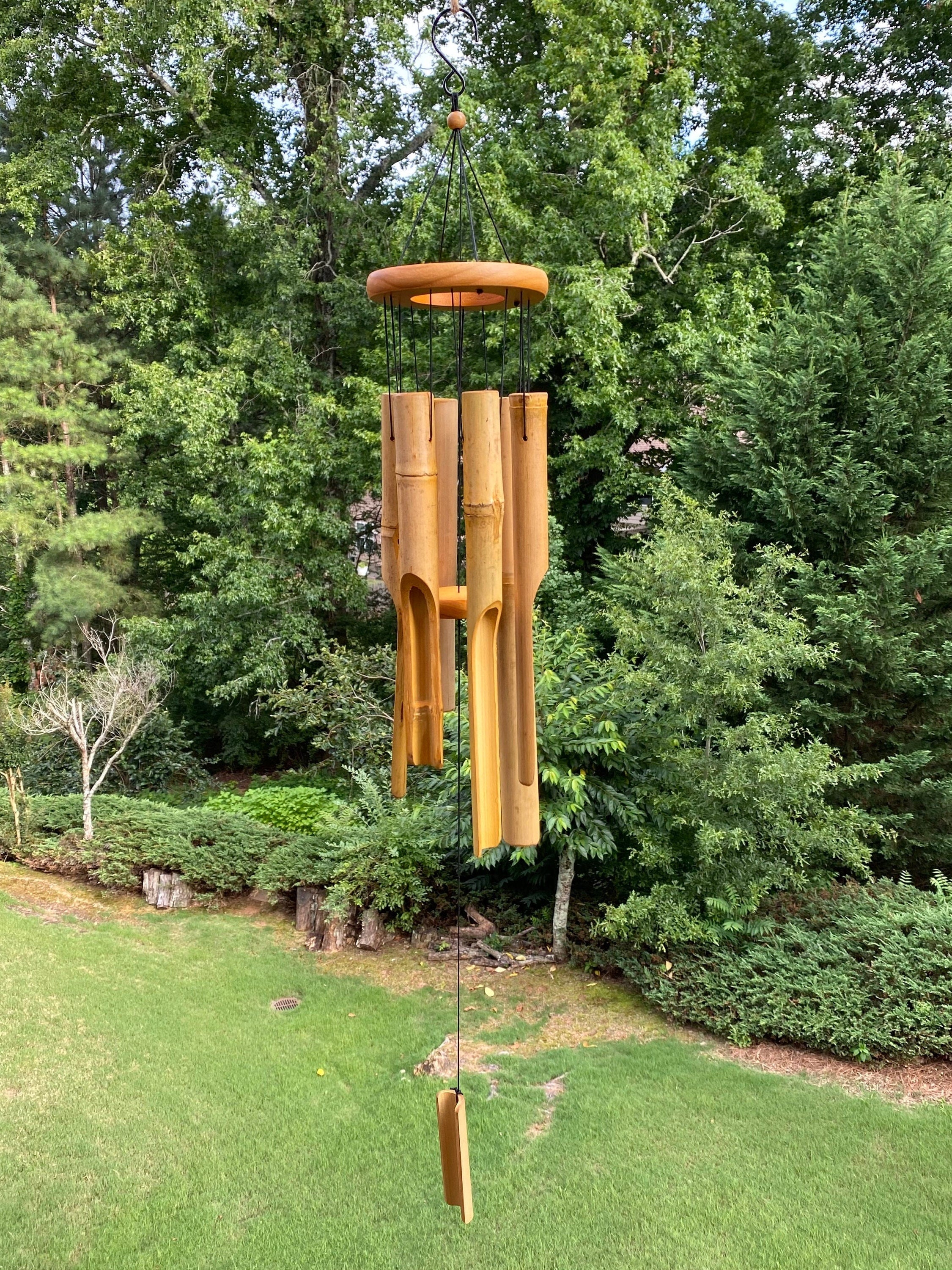 Bamboo wind chimes with wooden top hanging, creating deep relaxing tones