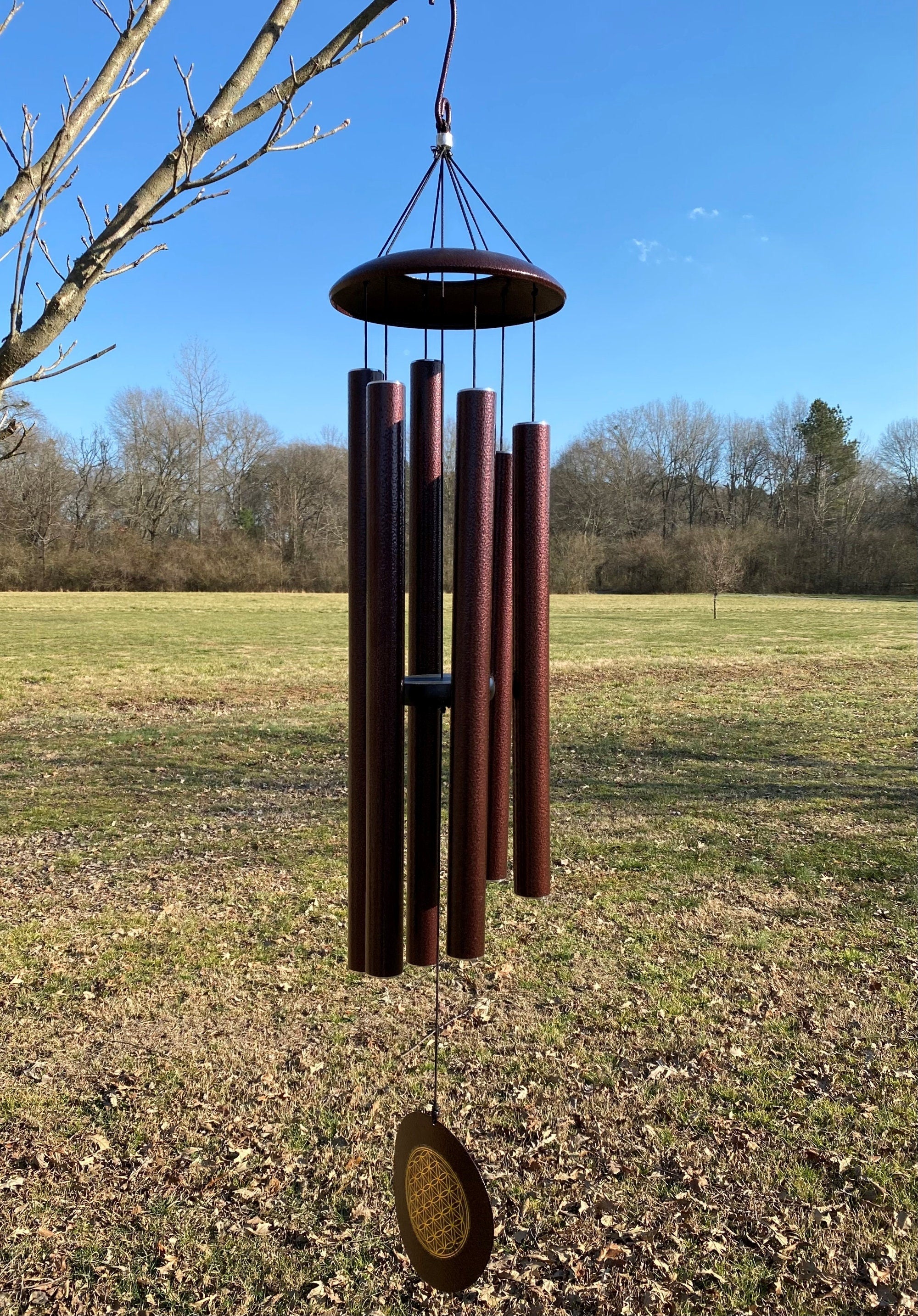 Wind chimes with dark brown metal tubes and a circular top piece, 45 inch bronze chimes