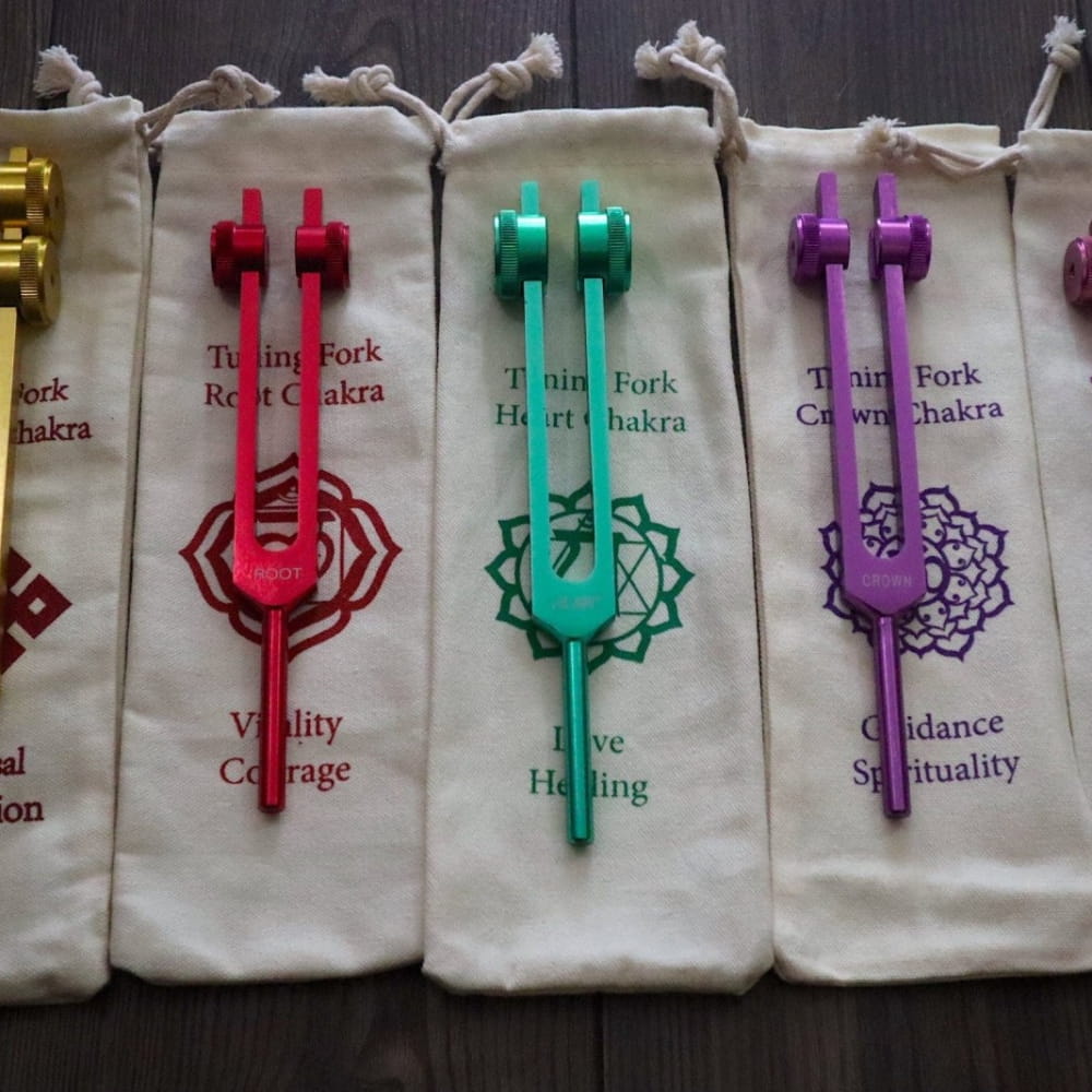Colorful tuning forks with chakra symbols in pouches for 528 Hz Solfeggio healing