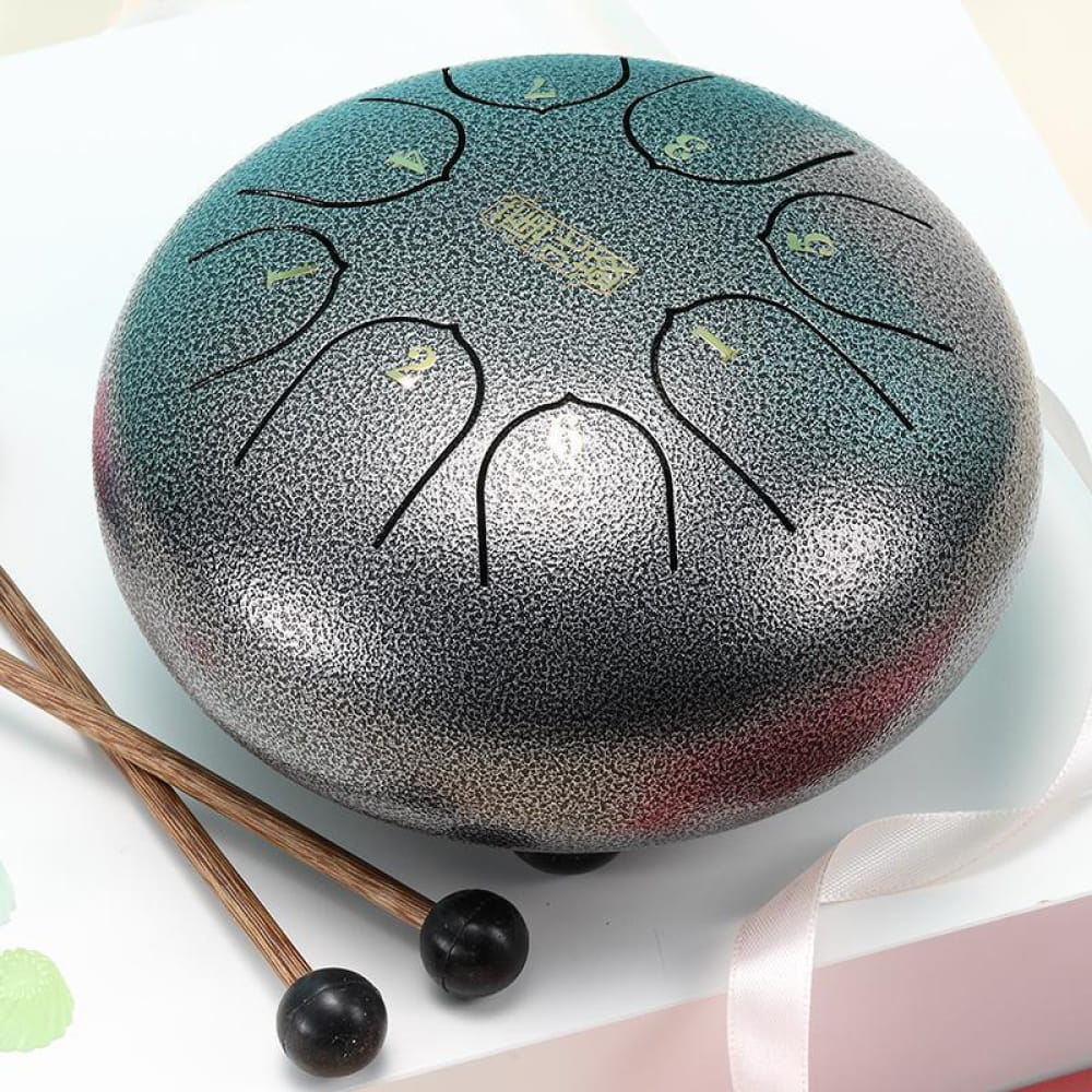 Steel tongue drum in teal-silver gradient with 8 tone fields for kids’ music