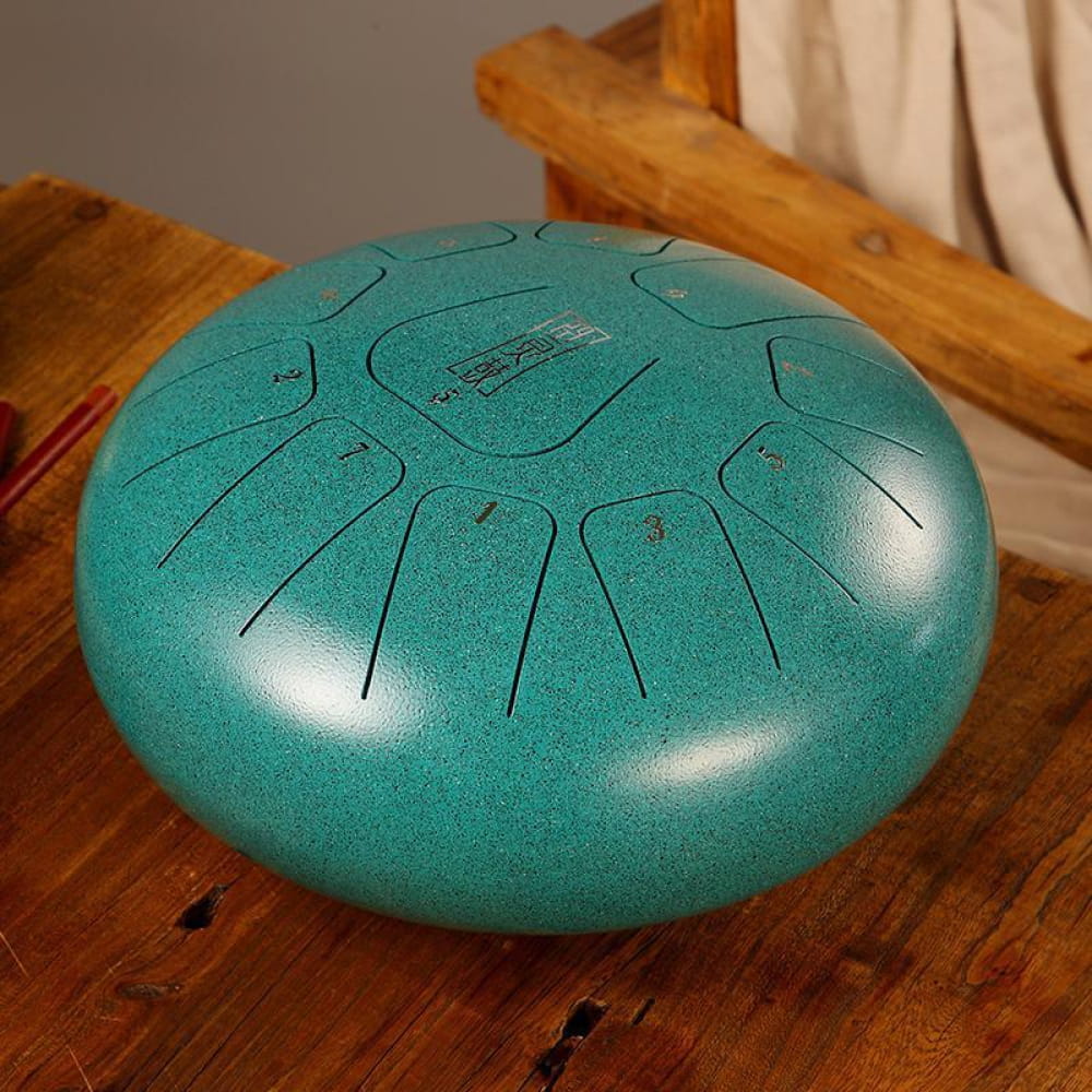 Turquoise steel tongue drum with patterned tones in 8 Square design, 11 Notes in F Key