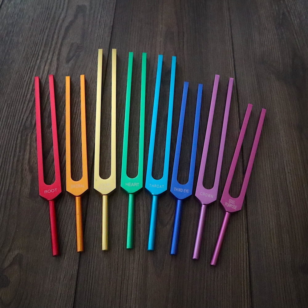 Rainbow-colored tuning forks in a row from the 8pc Chakra Tuning Fork Set