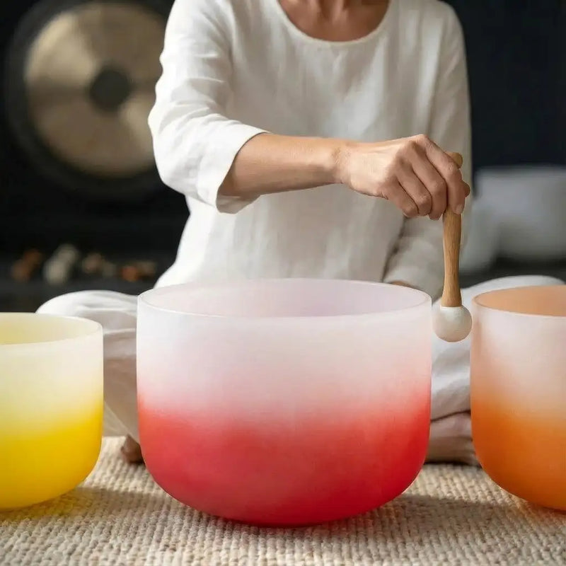 A translucent gradient glass singing bowl with a smooth, rounded rim and a vibrant red-to-white color transition.
