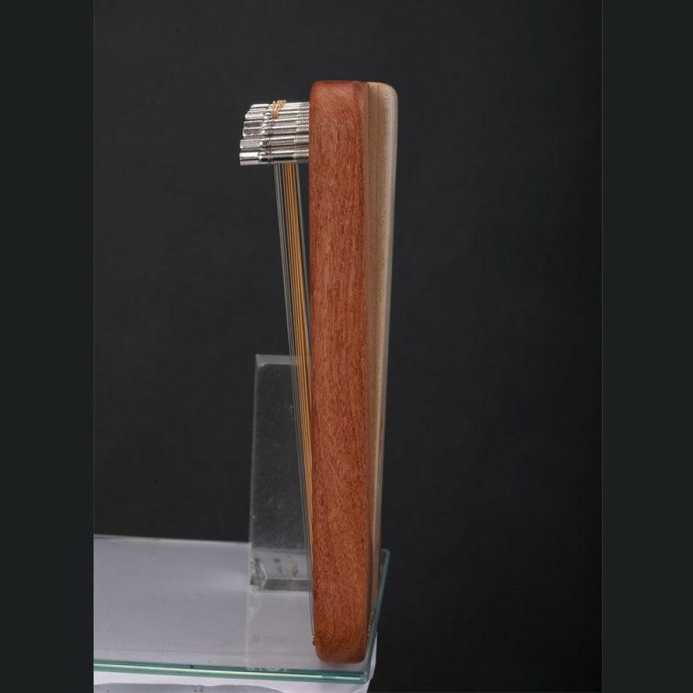 Safety razor with wooden handle next to Adjustable 17/31-String Lyre Harp in C Tone