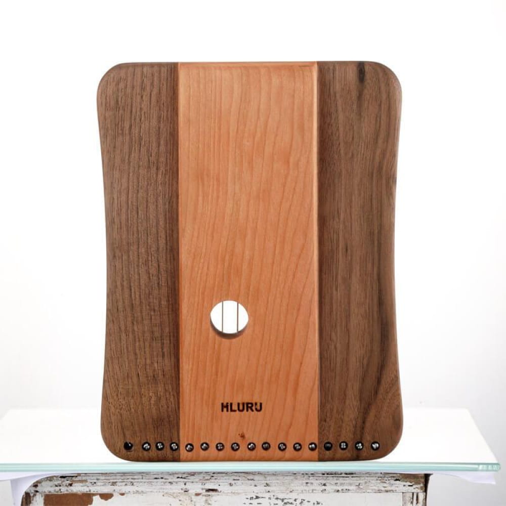 Wooden cutting board with contrasting stripes and a circular hole for kitchen use