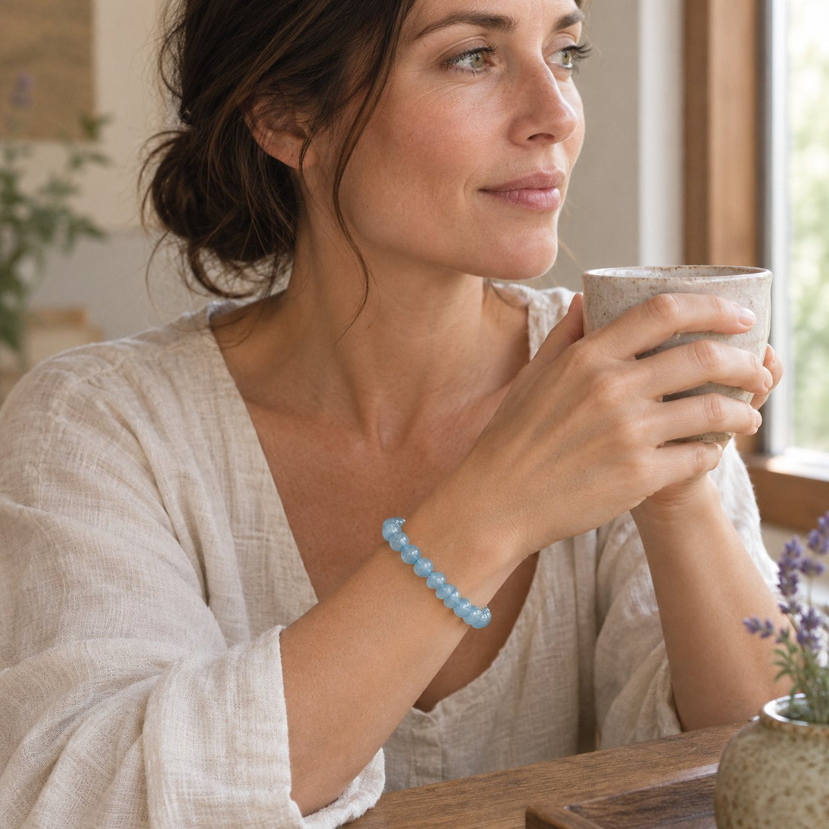 8mm Aquamarine Healing Beads Peace Bracelet, worn by a woman in a calm everyday moment