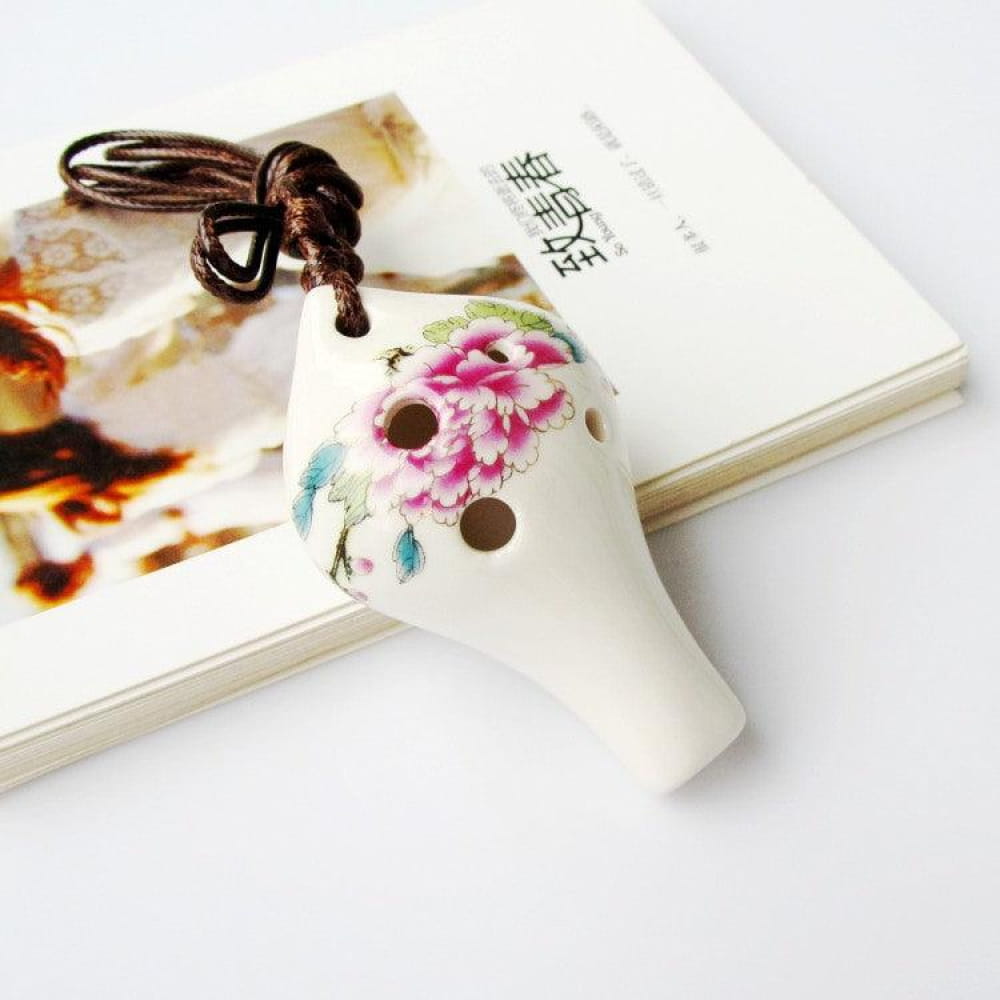 White ceramic ocarina with pink floral design and brown cord for Beginners 6-Hole Alto C