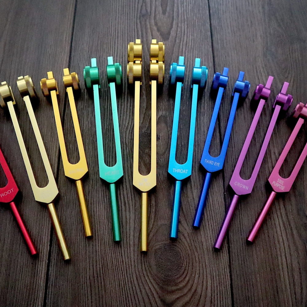 Rainbow-colored tuning forks in a fan pattern for Chakra Healing and energy balance