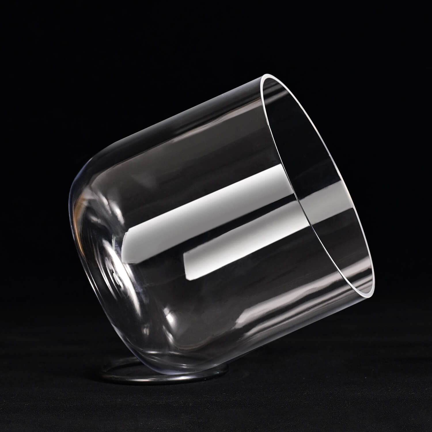 Clear glass tumbler tilted, highlighting Clear Quartz Crystal Singing Bowl for Chakra Healing
