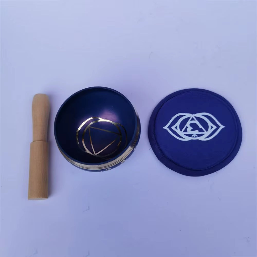 Two circular makeup compacts and a beige tube on a plain surface for meditation use