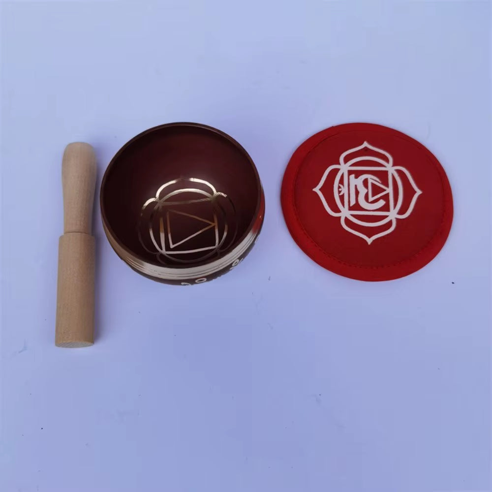Root chakra meditation bowl with wooden striker and red disc for meditation
