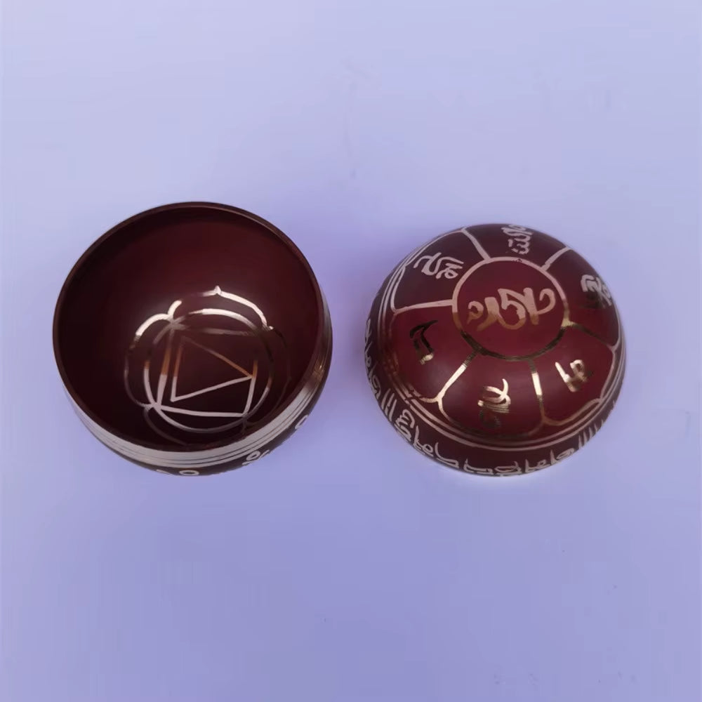 Two brown ceramic bowls with etched patterns beside a Colorful Brass Tibetan Singing Bowl