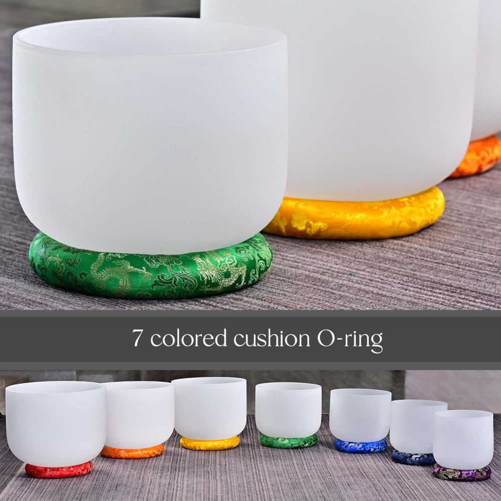 White crystal singing bowls on colorful cushioned O-rings for enhanced sound