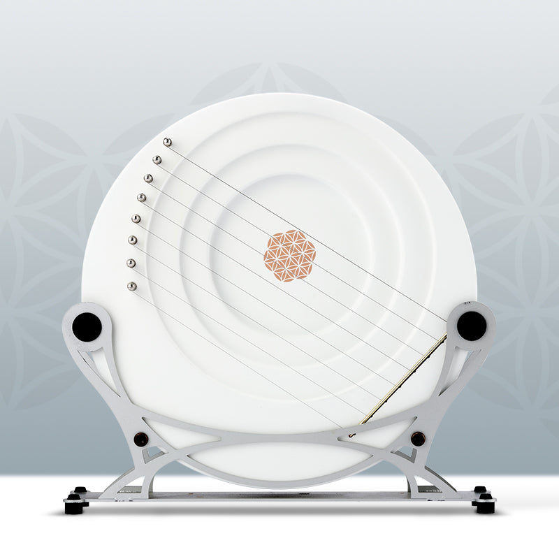 White Full Moon Lyre Harp with strings on a metal stand for musical performance