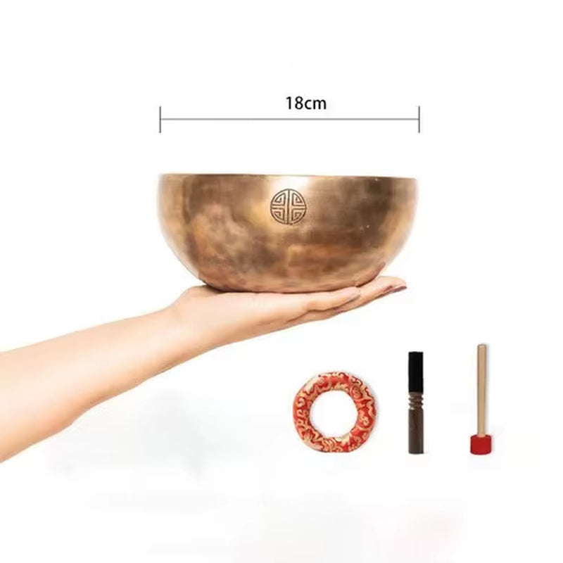 Bronze Tibetan singing bowl with etched symbol design for meditation and yoga