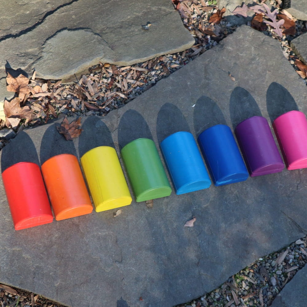 Row of rainbow-colored plastic cups in spectrum order for Healing Tuning Fork Activators