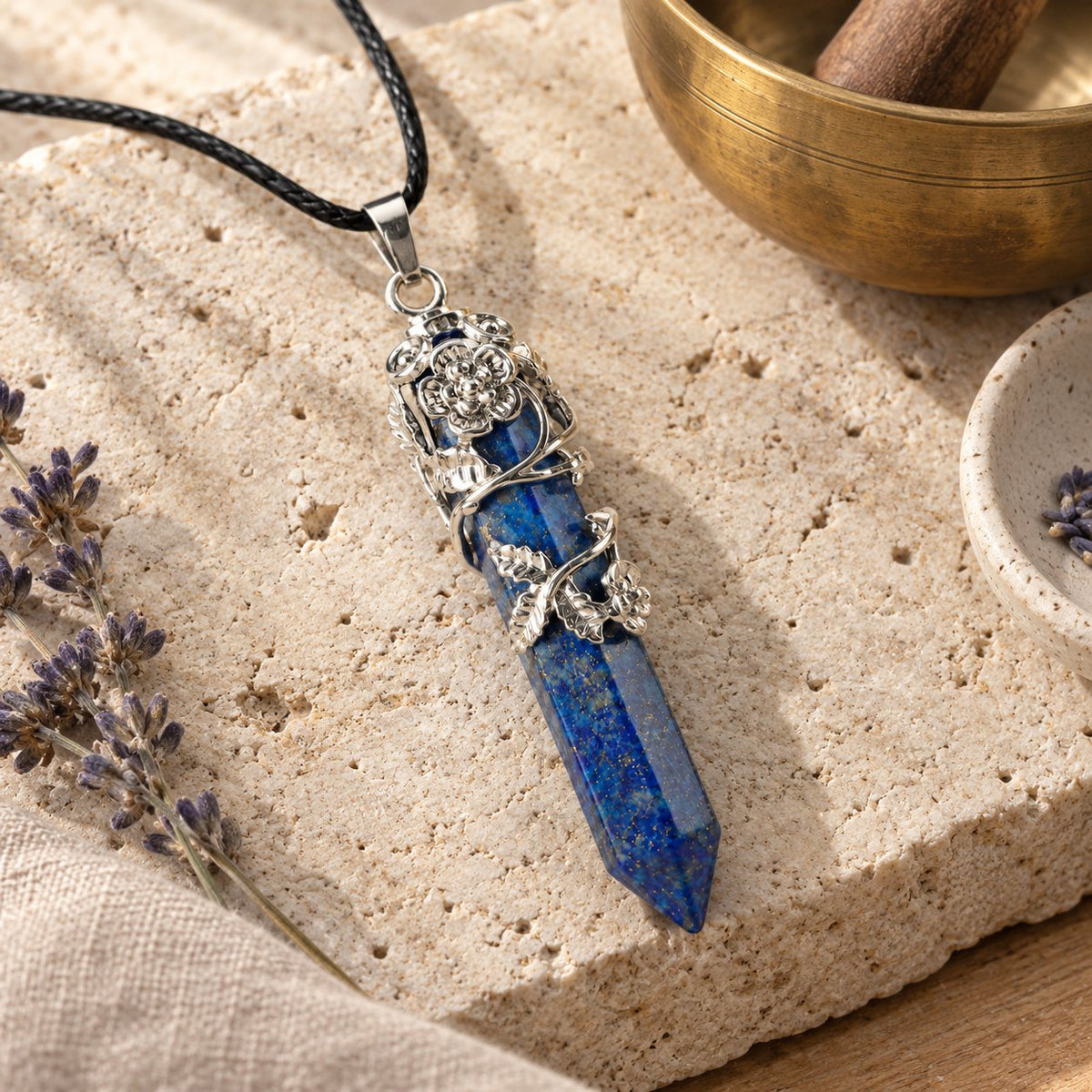 Healing Lapis Lazuli Silver Crystal Point Pendant, styled with a singing bowl and lavender