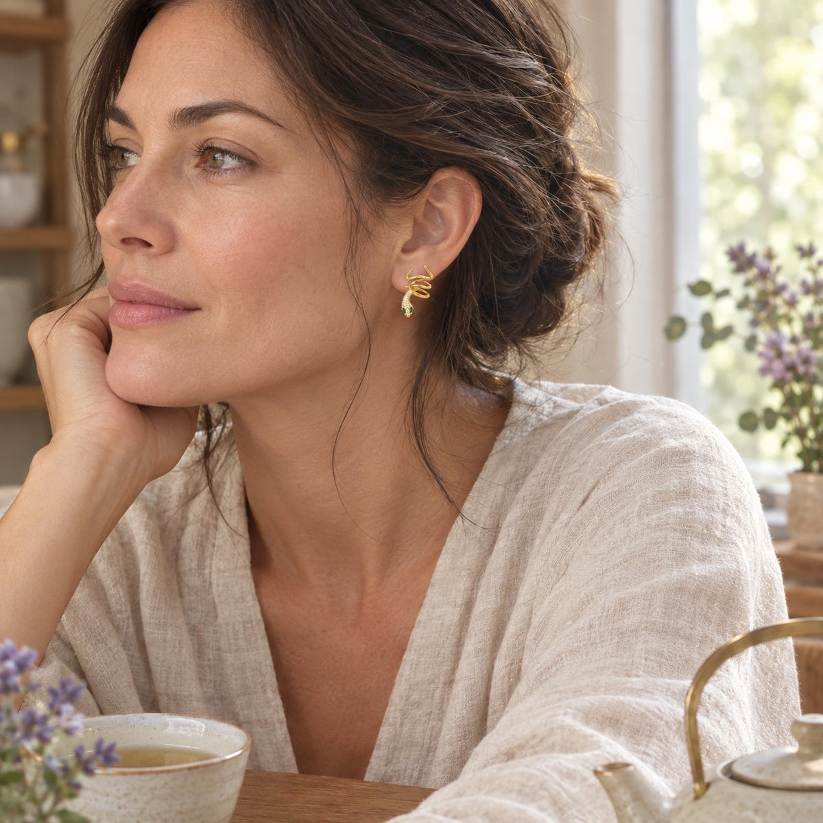 925 Sterling Silver Green-eyed Snake Earrings for Harmony, worn by a woman in a calm everyday moment