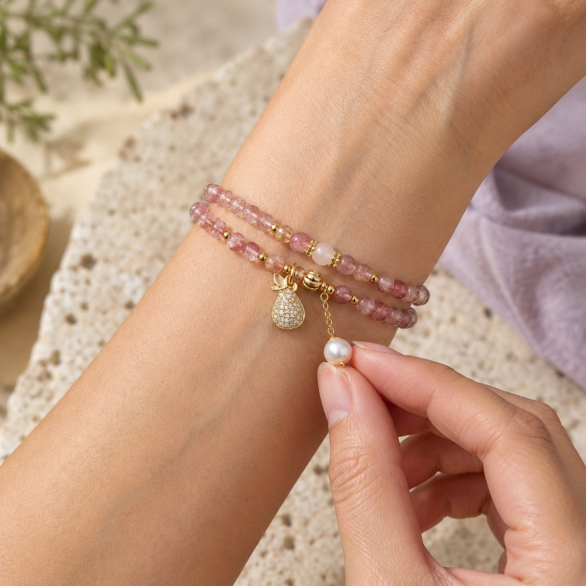 Double Wrap Strawberry Quartz Love Healing Bracelet, held in the hand to show its real size