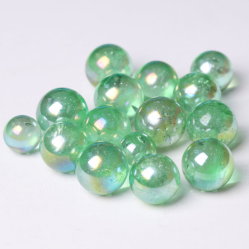 Iridescent light green glass marbles from the Aura Green Crystal Sphere healing orb collection