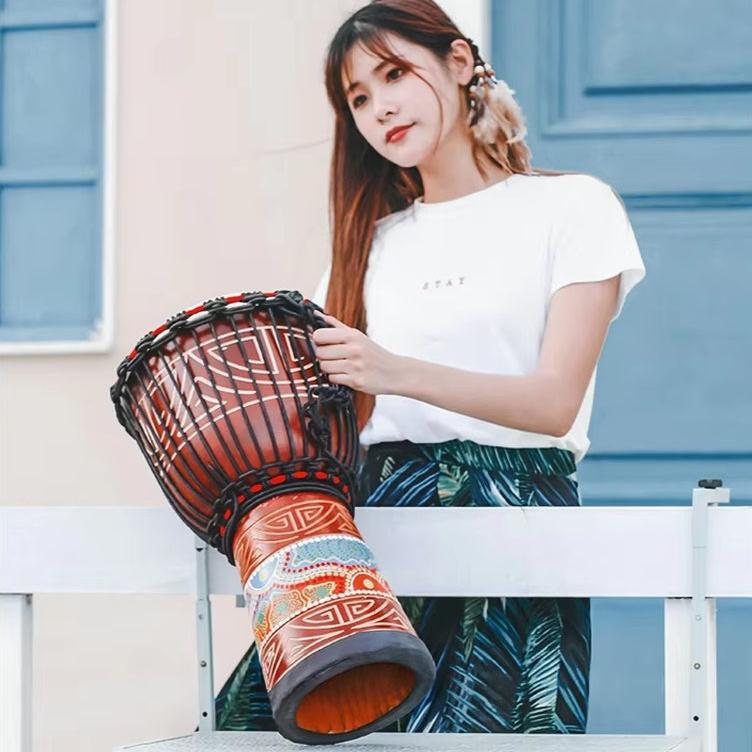 Traditional African Djembe Drum with carved patterns and woven rope tuning system