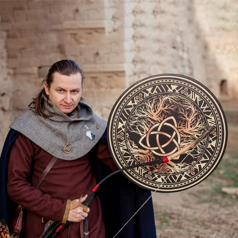 Ornate circular shield with Celtic knots and trees in black and copper tones on drum