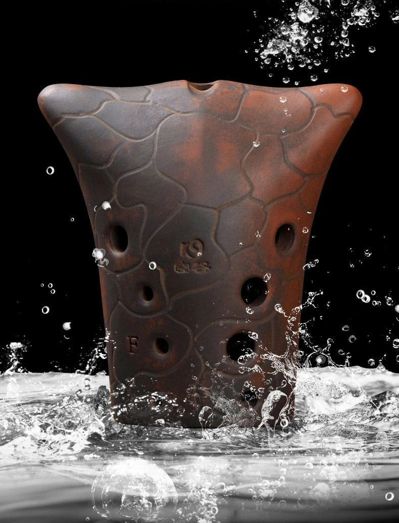 Perforated brown clay pot splashing in water for 10-Hole Double Cavity Chinese Xun