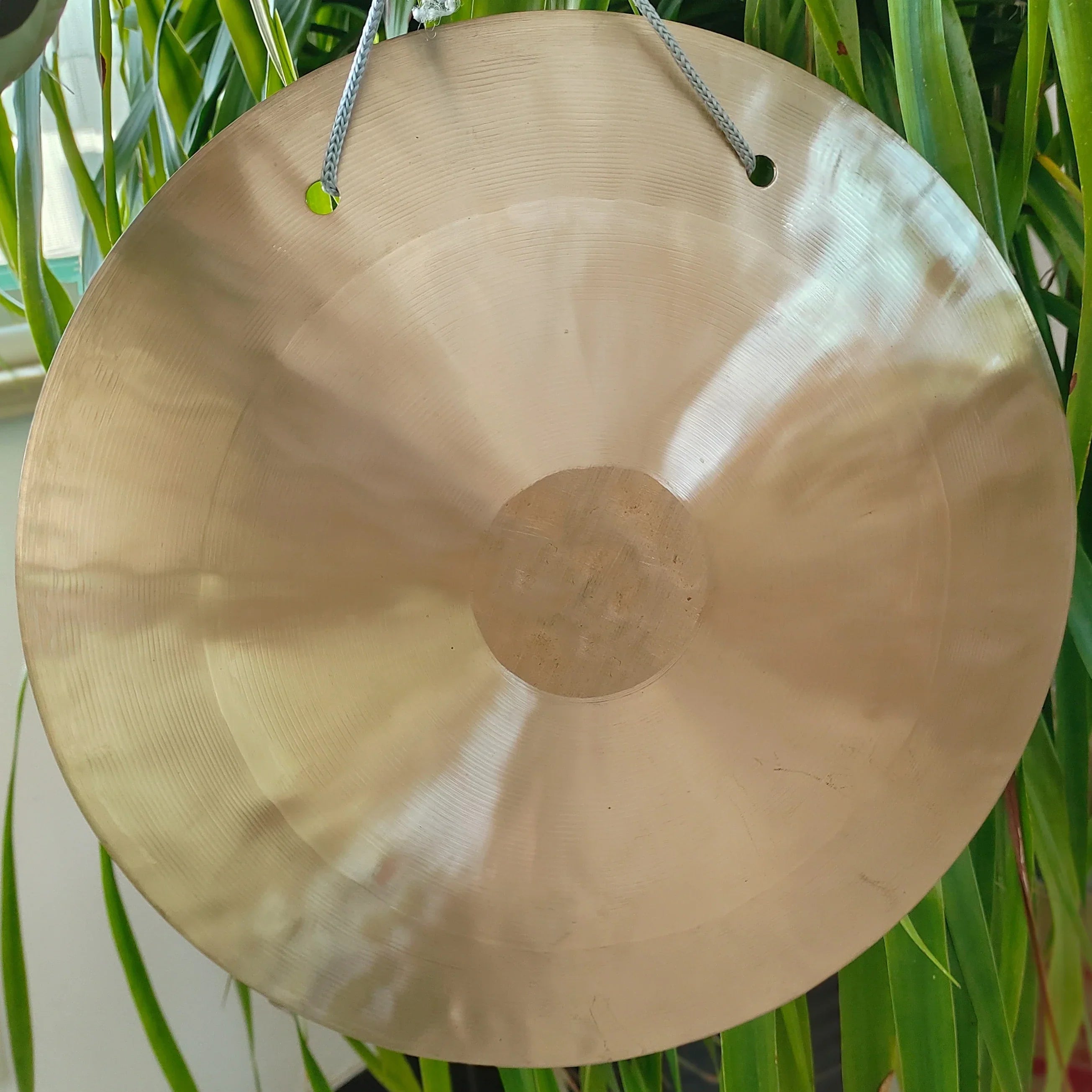 Metallic gong with central boss and hanging cord for 10-inch sound healing instrument