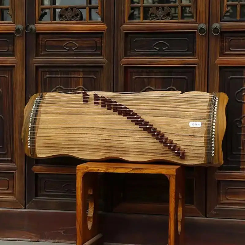 Traditional Japanese Koto stringed instrument on a wooden stand, showcasing exquisite craftsmanship