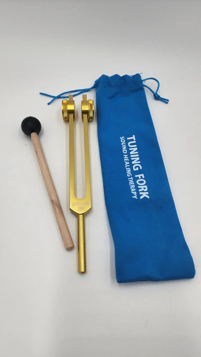 Gold 100 Hz Tuning Fork with mallet and blue storage pouch for healing therapy