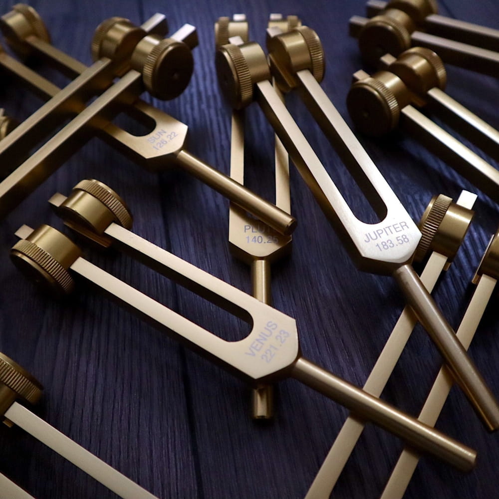 Collection of brass tuning forks from the 11pc Planetary Tuning Fork Set for sound healing