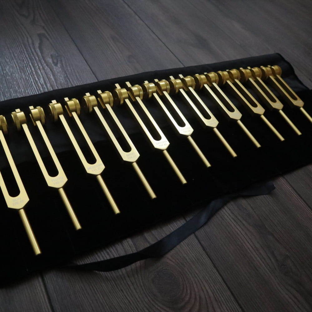 Set of golden tuning forks on black fabric for 11pc Planetary Tuning Fork Set