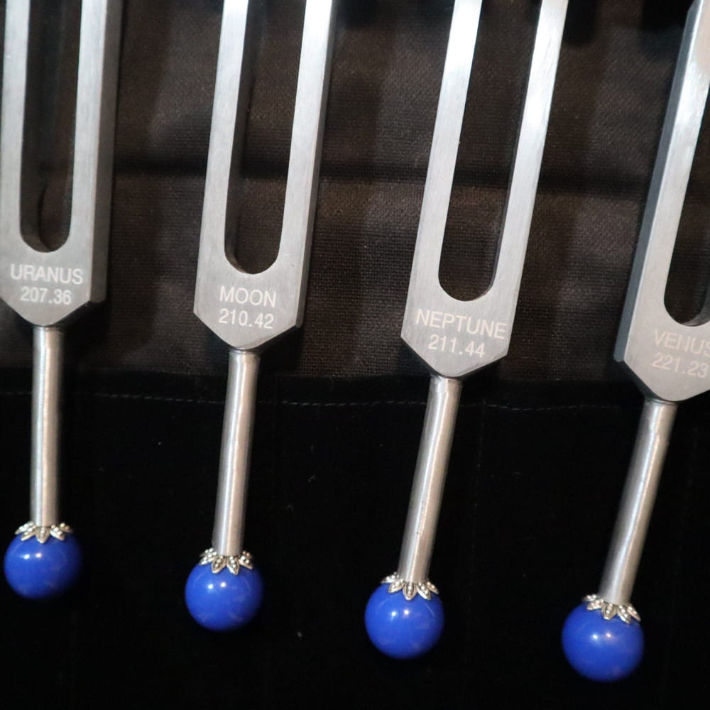 Metal tuning forks with blue spherical ends from 11pc Planetary Tuning Fork Set