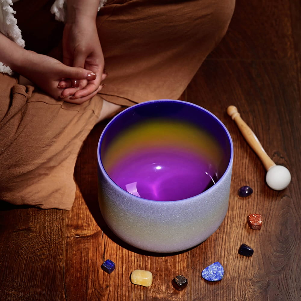 Crystal Singing Bowl with purple light and rainbow reflections for healing sound therapy