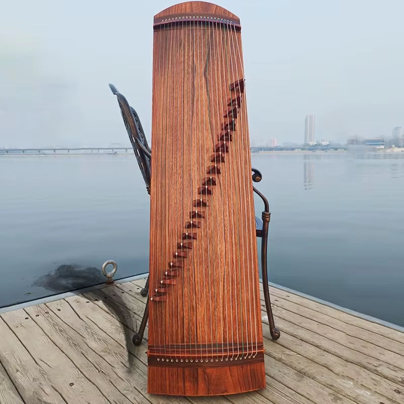 Wooden Guzheng Zither instrument made of Paulownia wood displayed upright