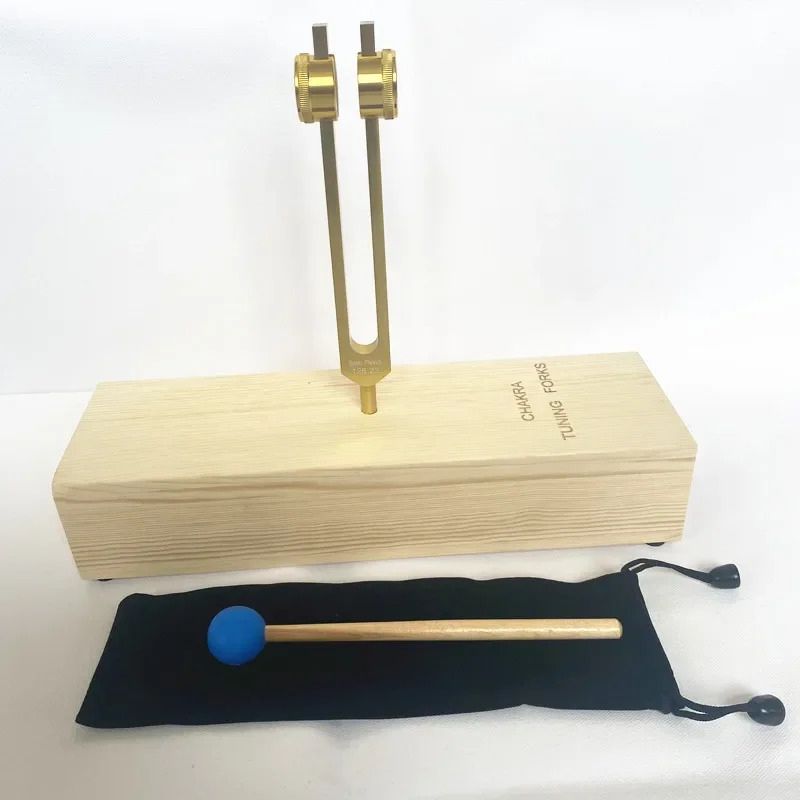 Tuning fork on wooden resonance box with mallet for Solar Plexus Chakra healing