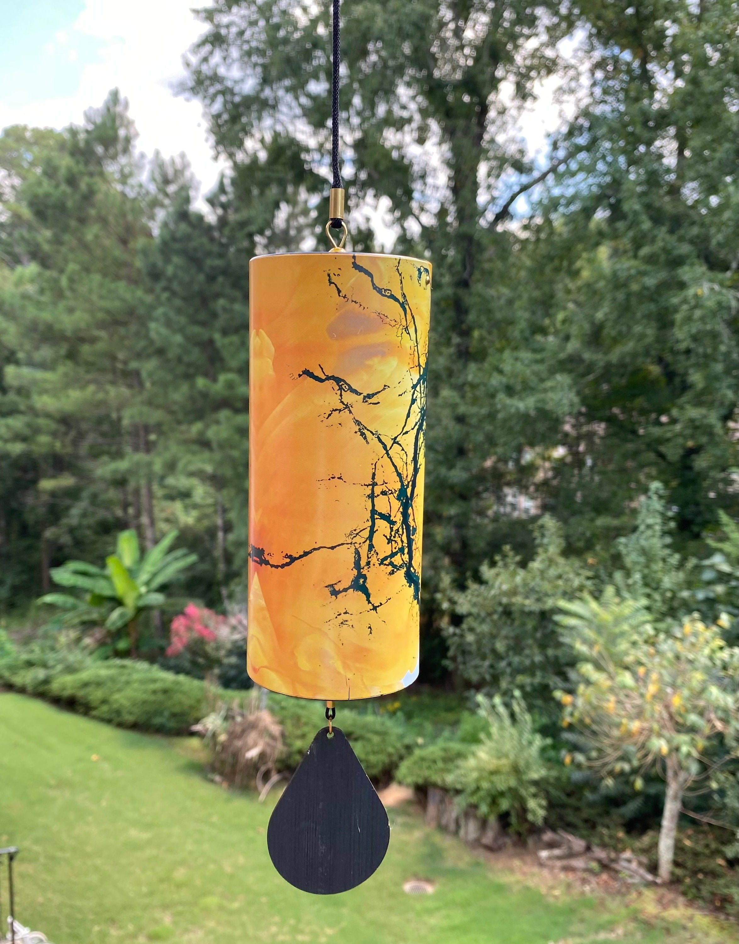 Cylindrical orange lantern with tree branch designs and pendant for 15’’ Yellow Wind Chimes