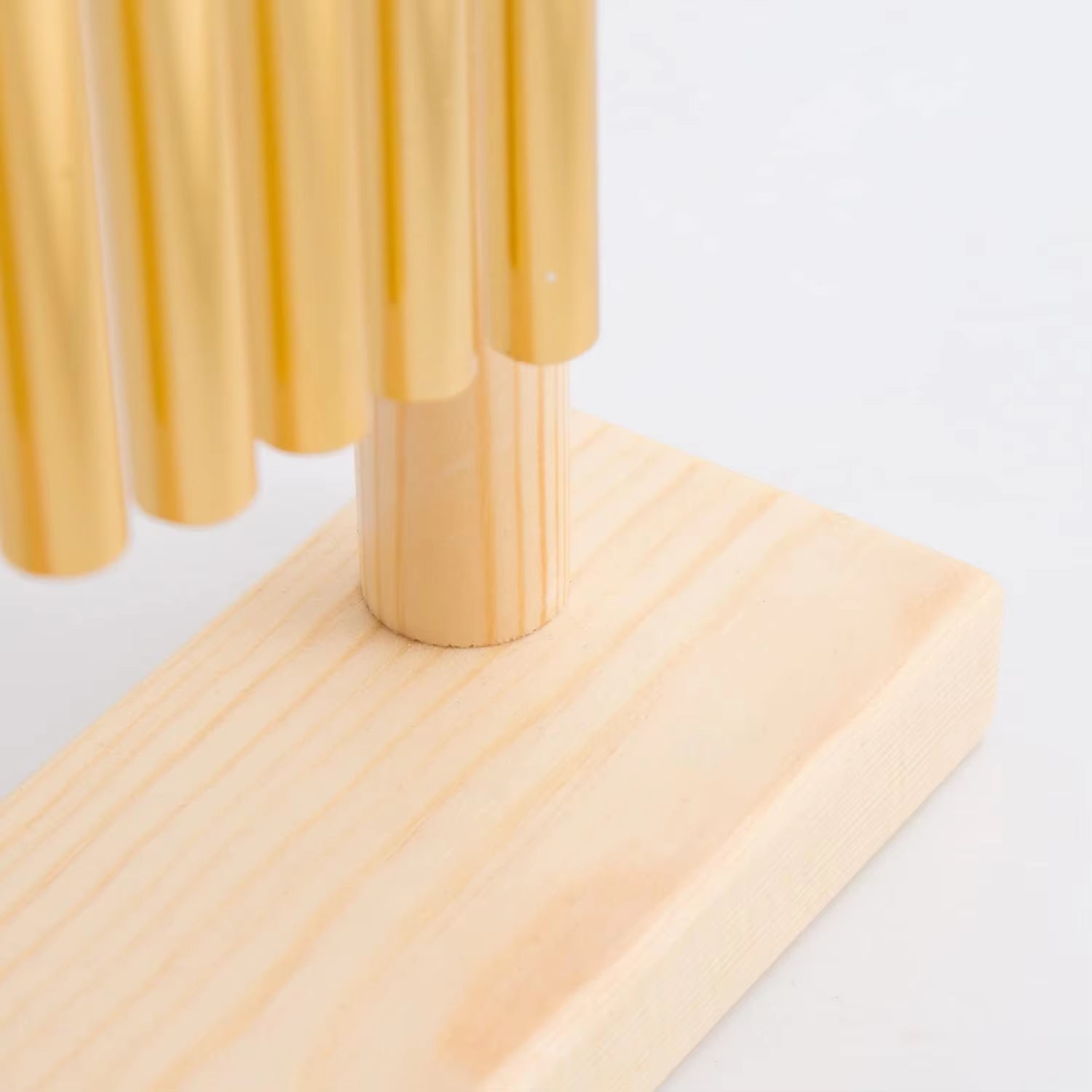 Wooden dowels arranged vertically on a light base for 20-Bar Swing Chimes with Mallet