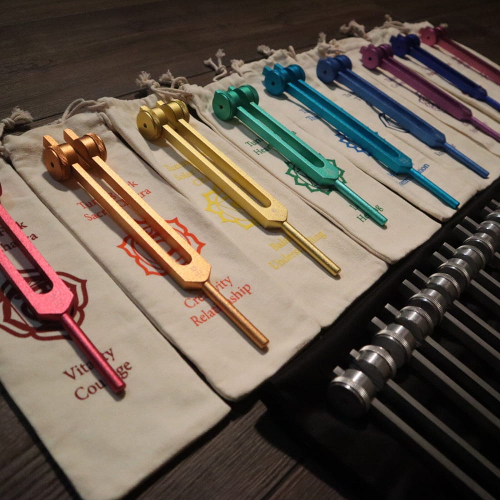 Colorful tuning forks in a row from the 20pc Solfeggio & Planetary Tuning Fork Set